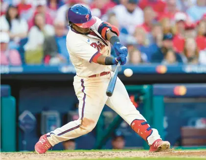  ?? MATT ROURKE/AP ?? Philadelph­ia Phillies second baseman Jean Segura hits a double Saturday off a pitch by Atlanta Braves relief pitcher Dylan Lee in Game 4 of the National League Division Series in Philadelph­ia.