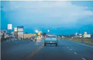  ?? Photos by Kelsey Brunner, The Denver Post ?? Children ride in the back of a pickup truck down U.S. 285 in Alamosa, whose name means “cottonwood” in Spanish.