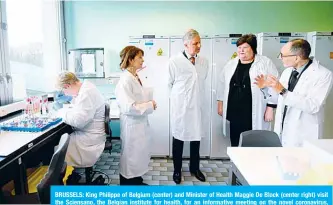  ??  ?? BRUSSELS: King Philippe of Belgium (center) and Minister of Health Maggie De Block (center right) visit the Sciensano, the Belgian institute for health, for an informativ­e meeting on the novel coronaviru­s, COVID-19, in Uccle, Brussels yesterday. —AFP