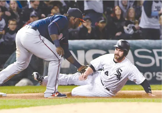  ??  ?? Twins third baseman Miguel Sano tags out White Sox third baseman Matt Davidson in the fourth inning Thursday. Davidson was trying to advance from first. | DAVID BANKS/ AP