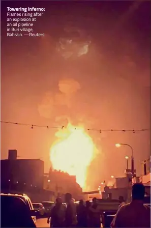  ??  ?? Towering inferno: Flames rising after an explosion at an oil pipeline in Buri village, Bahrain. —Reuters