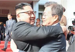  ?? AFP/GETTY IMAGES ?? North Korean leader Kim Jon Un, left, and South Korean leader Moon Jae-in hug at Saturday’s meeting.