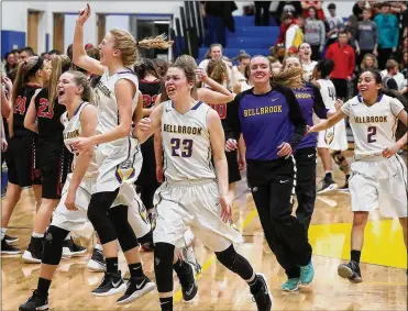  ?? BILL LACKEY/STAFF ?? The Bellbrook girls basketball team celebrates after beating Tippecanoe on Friday in a regional final at Springfiel­d High School. The 47-41 win clinched a state berth for the Eagles.