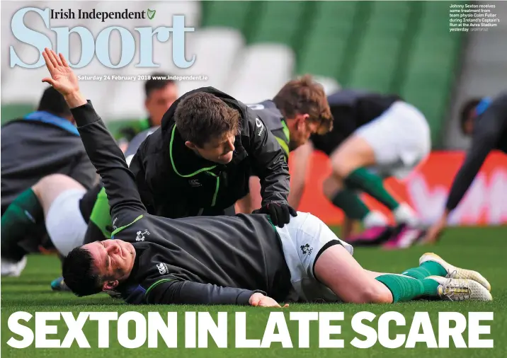  ?? SPORTSFILE ?? Johnny Sexton receives some treatment from team physio Colm Fuller during Ireland’s Captain’s Run at the Aviva Stadium yesterday