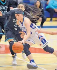  ?? JIM THOMPSON/JOURNAL ?? West Mesa’s Emily Burk drives to the basket as Oñate’s Kiyana Williams defends during the Mustangs’ win in the first round of the Class 6A state tournament Friday.