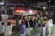  ?? NAVEED ALI — THE ASSOCIATED PRESS ?? Rescue workers unload earthquake victims from an ambulance at a hospital in Saidu Sharif, a town in Pakistan’s Swat valley, on Tuesday.