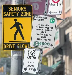  ?? RICK MADONIK TORONTO STAR ?? An official-looking street sign in support of Black Lives Matter appeared among a collection of city parking signs at Queen Street West and O’Hara Avenue.