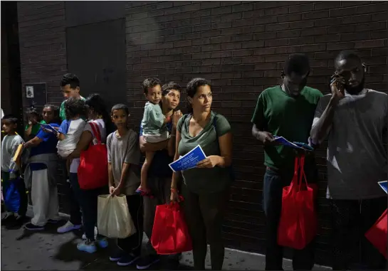  ?? TODD HEISLER — NEW YORK TIMES FILE ?? A mother from Venezuela and her sons are among three busloads who traveled from Brownsvill­e, Texas, to the Port Authority Bus Terminal in New York, where they were met and guided by advocates on Aug. 22. The migrant busing program altered the debate over immigratio­n. Gov. Greg Abbott wants to give Texas police expanded powers over border enforcemen­t.