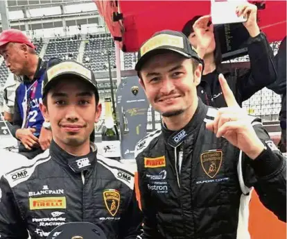  ??  ?? Well done: Afiq Ikhwan Yazid (left) and his Italian partner Kei Cozzolino won a second straight overall title in the Lamborghin­i Super Trofeo Asia Series after winning Race 1 in the fifth round at the Shanghai Internatio­nal Circuit in China.