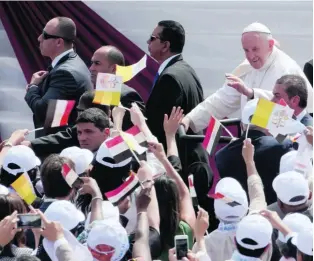  ?? Amr Nabil / AP Photo ?? Pope Francis waves as he arrives to celebrate mass at a sports stadium in Cairo.