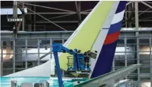  ?? — Reuters ?? Boeing employees work on the tail of a Boeing 737 NG at the Boeing plant in Renton, Washington.