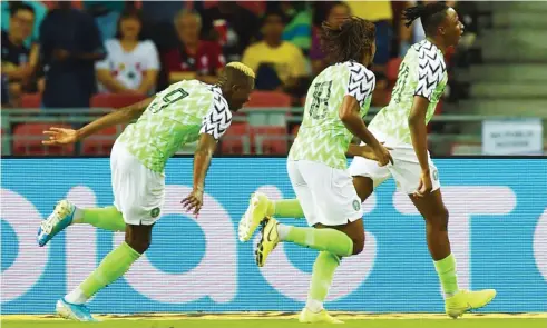  ??  ?? Glasgow Rangers and Super Eagles midfielder, Joe Aribo celebrates with team mates Alex Iwobi and Victor Osimhen after scoring against Brazil on Sunday in Singapore