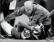  ?? ASSOCIATED PRESS ?? IN THIS NOV. 3, 2013, FILE PHOTO, Minnesota Vikings cornerback Xavier Rhodes (29) is attended to by head trainer Eric Sugarman during the second half against the Dallas Cowboys in Arlington, Texas.