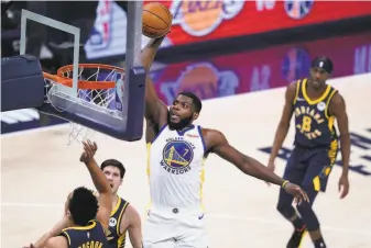  ?? Darron Cummings / Associated Press ?? Warriors forward Eric Paschall dunks against the Indiana Pacers in a home game on Feb. 24.