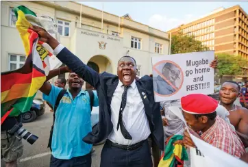  ?? Picture: AP Photo ?? ONE VOICE: Zimbabwean­s celebrate outside the parliament building immediatel­y after hearing the news that President Robert Mugabe had resigned. Mugabe resigned as president with immediate effect yesterday after 37 years in power, shortly after...