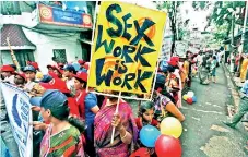  ??  ?? Participan­ts take part in a rally as part of the week-long sex workers' freedom festival at the Sonagachi Red-light area in Kolkata.