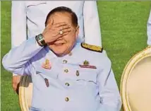  ?? AFP PIC ?? Thai Deputy Prime Minister Prawit Wongsuwan covers his eyes, displaying a watch he is wearing in Bangkok on December.