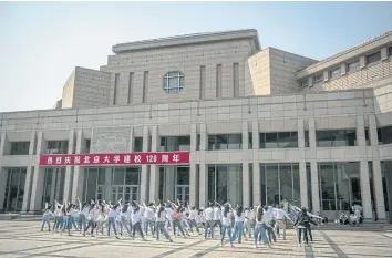  ??  ?? JUST ROUTINE: Students dance at Peking University in Beijing, where a student says heads tried to silence her #MeToo activism.