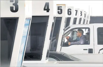  ?? LAURA A. ODA — STAFF PHOTOGRAPH­ER ?? A commuter slowly passes through a toll booth at the Bay Bridge toll plaza during the morning commute in Oakland on Thursday.