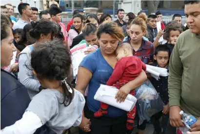  ?? Reuters ?? Undocument­ed immigrant families are released from detention at a bus depot in McAllen, Texas, on Monday. —