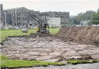  ?? BARRY GRAY THE HAMILTON SPECTATOR ?? An excavator digs up the grass on the sports field behind Westdale Secondary School just days after students returned to class.