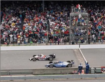  ?? The Associated Press ?? THE GREATEST RACE: Al Unser Jr., top, wins the Indianapol­is 500 by less than a car length ahead of Scott Goodyear on May 24, 1992, in the 76th running of the race at Indianapol­is Motor Speedway in Indianapol­is. The Associated Press has updated its survey of living Indianapol­is 500 winners and their pick as the greatest race in the long history of the event. There are six races that received multiple votes, topped by Unser victory over Goodyear in 1992 — the closest Indy 500 in history. The others are Emerson Fittipaldi’s win in 1989; Sam Hornish Junior’s win in 2006; the 1982 battle between Rick Mears and Gordon Johncock; the 2011 race won by the late Dan Wheldon; and the 2014 thriller won by Ryan Hunter-Reay.