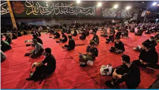  ??  ?? TEHRAN: Iranians wearing facemasks attend prayers during Ramadan outside a mosque early yesterday. — AFP