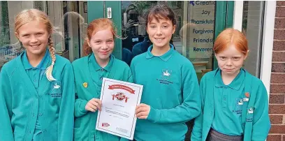  ?? ?? ●●Bollington St John’s Primary pupils with their Global Neighbours bronze award