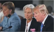  ?? EPA ?? From left, German Chancellor Angela Merkel, Christine Lagarde, managing director of the Internatio­nal Monetary Fund, and the US President Donald Trump at the G7 summit in Canada