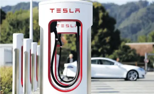  ?? STEFAN WERMUTH / BLOOMBERG ?? A Tesla Inc. Supercharg­er station in Switzerlan­d. Morgan Stanley suspended coverage on the electric-car maker on Tuesday, following the lead of Goldman Sachs, spurring speculatio­n the bank may play a role in going-private plans.