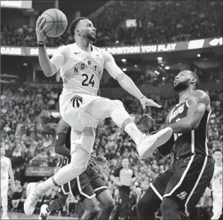  ?? Frank Gunn Associated Press ?? TORONTO FORWARD Norman Powell drives against LeBron James during the first half. Powell, in his fourth NBA season since leaving UCLA, scored 20 points off the bench for the Raptors.