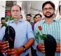  ?? — PTI ?? Aam Aadmi Sena activists hold roses and slippers as they protest at IGI Airport in New Delhi on Friday against Shiv Sena MP Ravindra Gaikwad over his misbehavio­ur with an Air India staffer.