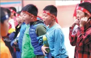  ??  ?? Boys shout slogans to boost their morale before a football match.