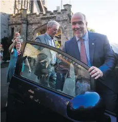  ?? DARRYL DYCK/THE CANADIAN PRESS ?? John Horgan gets into a Prius with his chief of staff Bob Dewar to leave Government House after speaking to the media outside following his meeting with Lt.-Gov. Judith Guichon. He had emerged from the meeting as premier-designate.