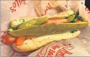  ?? Jeremy Kohler ?? THIS PORTILLO’S hot dog has been “dragged through the garden,” as the style is called in Chicago.