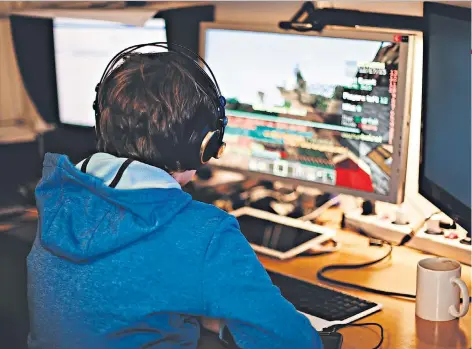  ??  ?? Addiction: some children are spending so much time playing games like Fortnite, below, that they are suffering physical and psychologi­cal side-effects