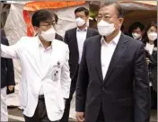  ?? PIC/PTI ?? In this photo, South Korean President Moon Jae-in, right, wearing a mask arrives to inspect the National Medical Center in Seoul