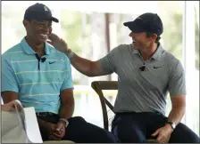  ?? (AP/Wilfredo Lee) ?? Golfers Tiger Woods (left) and Rory McIlroy share a laugh Tuesday as they discuss the future home of their tech-infused golf league that will begin play next year on the campus of Palm Beach State College in Palm Beach Gardens, Fla.