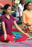  ?? — PTI ?? Students (above) practise yoga at Parade Ground in Allahabad and youth (right) perform yoga at a university in Meerut ahead of Internatio­nal Yoga Day on June 21.