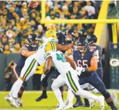  ??  ?? Bears quarterbac­k Brian Hoyer is tackled between Packers outside linebacker­s Julius Peppers, left, and Clay Matthews on Thursday night. Hoyer left the game after this play. Mike Roemer, The Associated Press