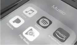  ?? Associated Press ?? ■ Music streaming apps are pictured clockwise from top left, Apple, Spotify, Amazon, Pandora and Google on an iPhone in New York. Music-streaming pioneer Spotify plans an initial public offering of stock. The first steps toward IPO were made in a...