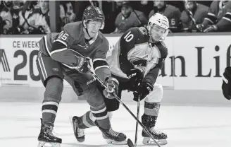  ?? Minas Panagiotak­is, Getty Images ?? Jesperi Kotkaniemi, left, of the Montreal Canadiens and the Avalanche’s Sven Andrighett­o battle for the puck Saturday night at the Bell Centre.