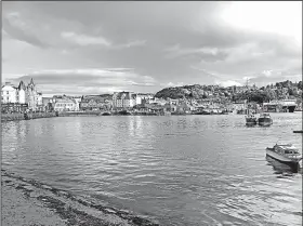  ?? Rick Steves’ Europe/CAMERON HEWITT ?? The picturesqu­e seaside town of Oban, on Scotland’s west coast, grew up around its distillery, which was founded in 1794.