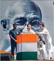  ?? PTI ?? Congress President Sonia Gandhi addresses as party's leader Rahul Gandhi passes her a hand written note, at an event to commemorat­e the 150th birth anniversar­y of Mahatma Gandhi after party's Gandhi Sandesh ‘Pad Yatra' from DPCC to Rajghat, in New Delhi, Wednesday