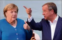  ?? (Photos EPA) ?? Angela Merkel et son poulain de l’union conservatr­ice CDUCSU, Armin Laschet, ne sont pas à la fête. Le SPD et leur chef de file Olaf Scholz les devancent légèrement.