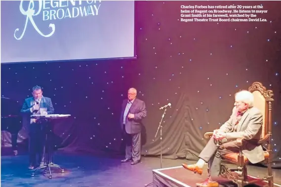  ??  ?? Charles Forbes has retired after 20 years at the helm of Regent on Broadway. He listens to mayor Grant Smith at his farewell, watched by the Regent Theatre Trust Board chairman David Lea.