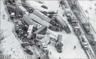  ?? ASSOCIATED PRESS ?? Cars and trucks pile up in a crash on Interstate 78 near Fredericks­burg, Pa., that involved at least 50 vehicles, killed three people and injured more than 40. It was blamed on a passing snow squall.