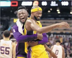  ?? Christian Petersen Getty Images ?? JULIUS RANDLE, left, embraces teammate Corey Brewer after Brewer sparked a Lakers victory at Phoenix by scoring 13 second-half points.