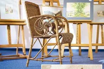  ?? AFP ?? Photo taken at the Weidler auction house in the southern German city of Nuremberg on Friday shows a wicker armchair bearing a swastika, which is presumed to have belonged to the late Nazi dictator Adolf Hitler. Inset shows the signature ‘AHitler’ on a watercolor painting titled ‘Im Wald’ (‘In the forest’).