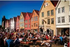 ??  ?? Norwegian notebook: Majestic fjords, top, vie with historic towns like Bryggen, above, and the spectacle of the Northern Lights, left